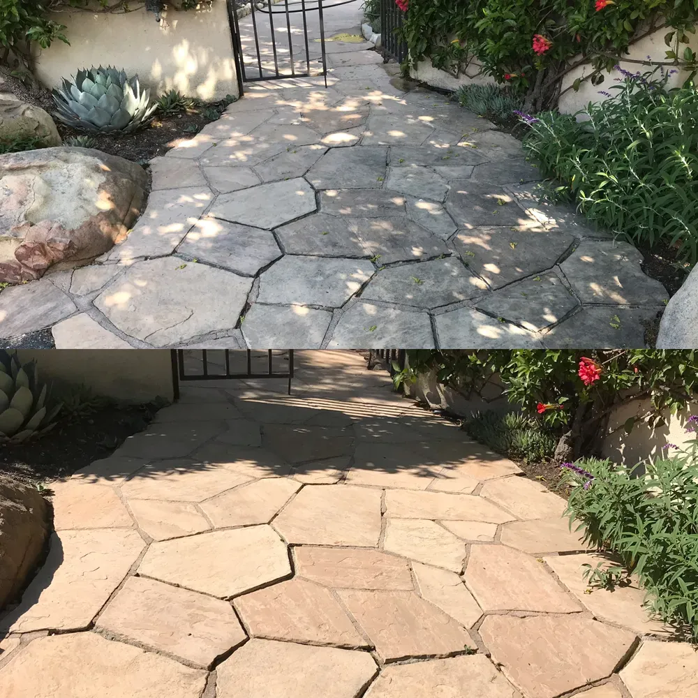 Flagstone walkway before and after soft washing, grime lifted to reveal warm natural stone